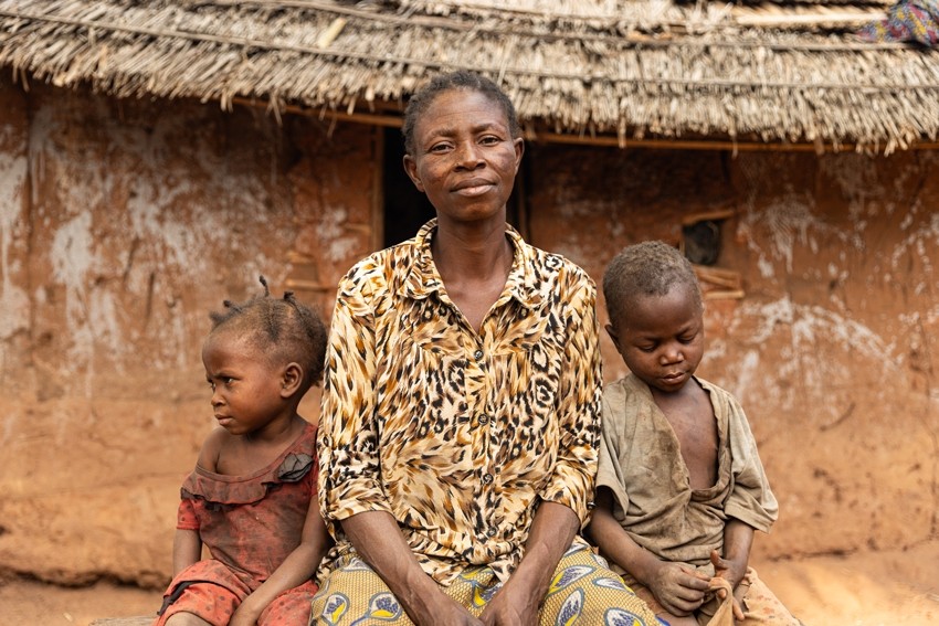 Nyange sits with malnourished children, Shitema (left) and Marine (right) in Kasai