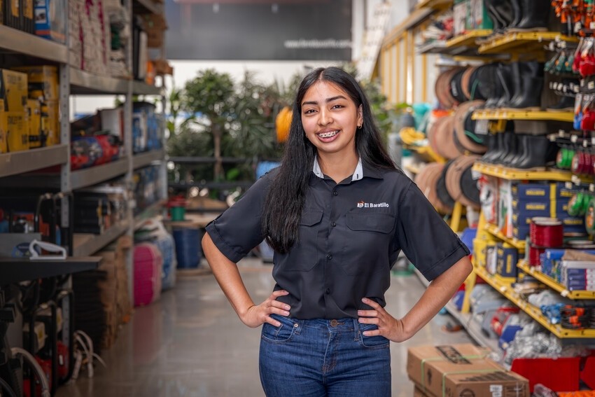 Dayana Fuentes proudly stands at her new job. 